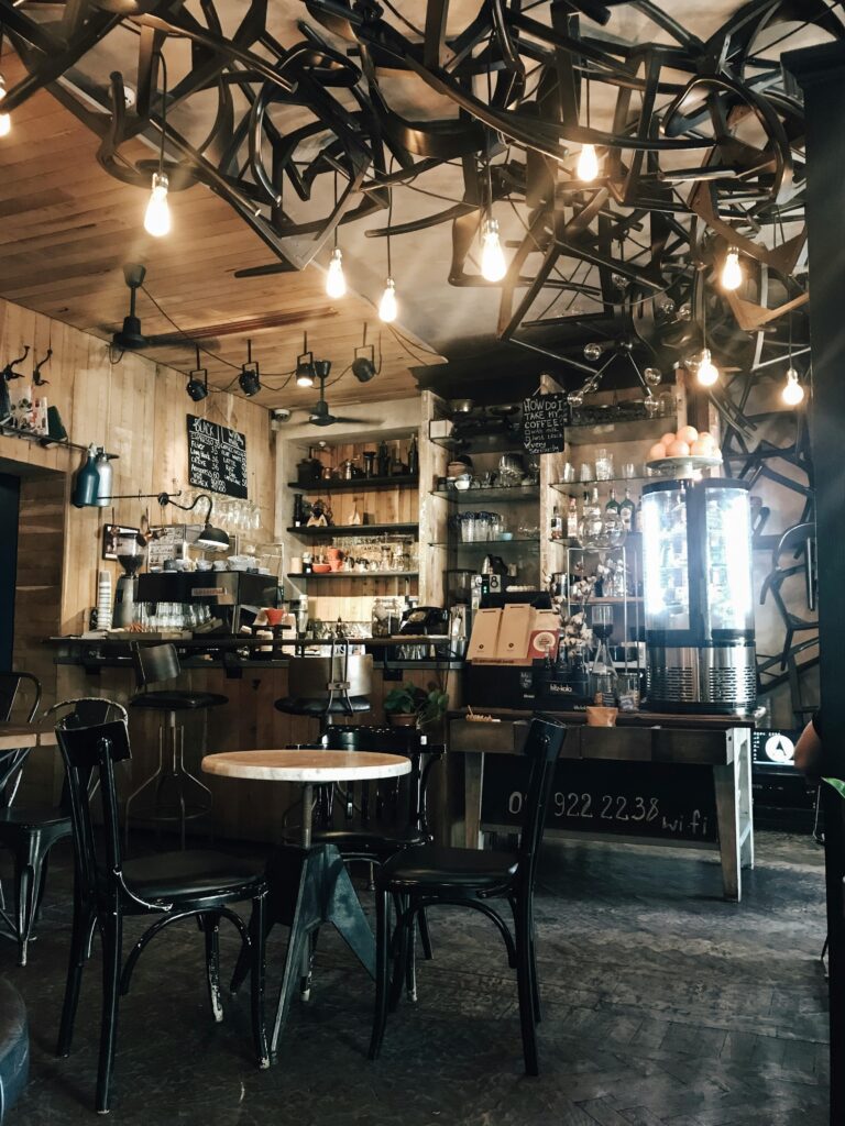 Warm and inviting modern coffee shop interior with unique lighting and wooden elements.